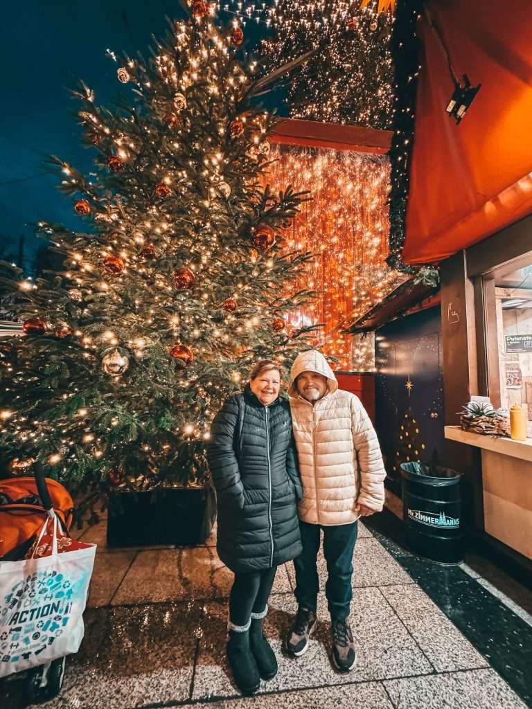Cologne Christmas Markets with charming wooden stalls, twinkling lights, and festive decorations, set against the backdrop of the impressive Cologne Cathedral.
