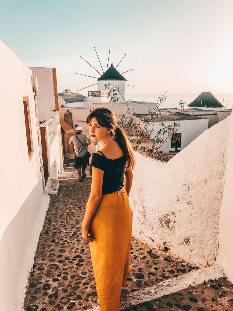 lady wandering the streets of Oia in Santorini