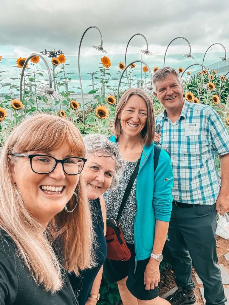 A group infront of tall sunflowers at Singapore Airport