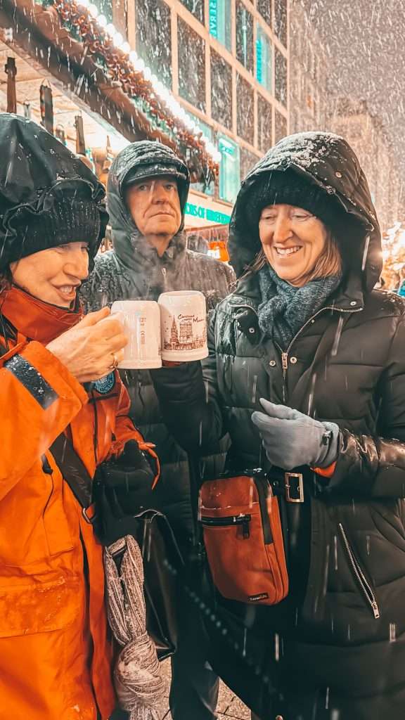 Our group bundled up in jackets and beanies, enjoying the snowy Munich weather with snowflakes gently falling around us