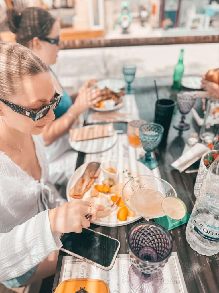 ladies eating in coralli restaurant Santorini