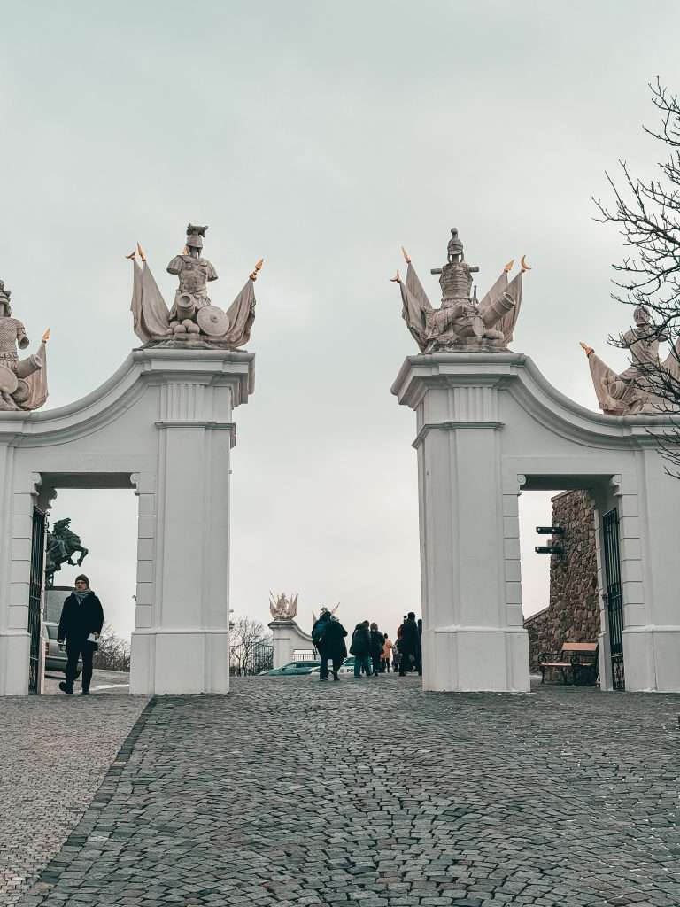 Bratislava at Christmas during the day, adorned with festive decorations, and the majestic Bratislava Castle overlooking the city under a clear winter sky.
