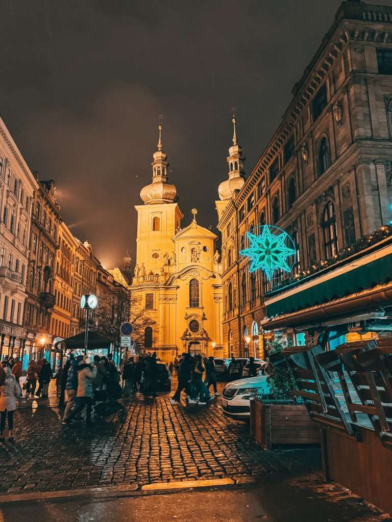 Prague at night during Christmas, illuminated with festive lights and decorations Seeds of Travel