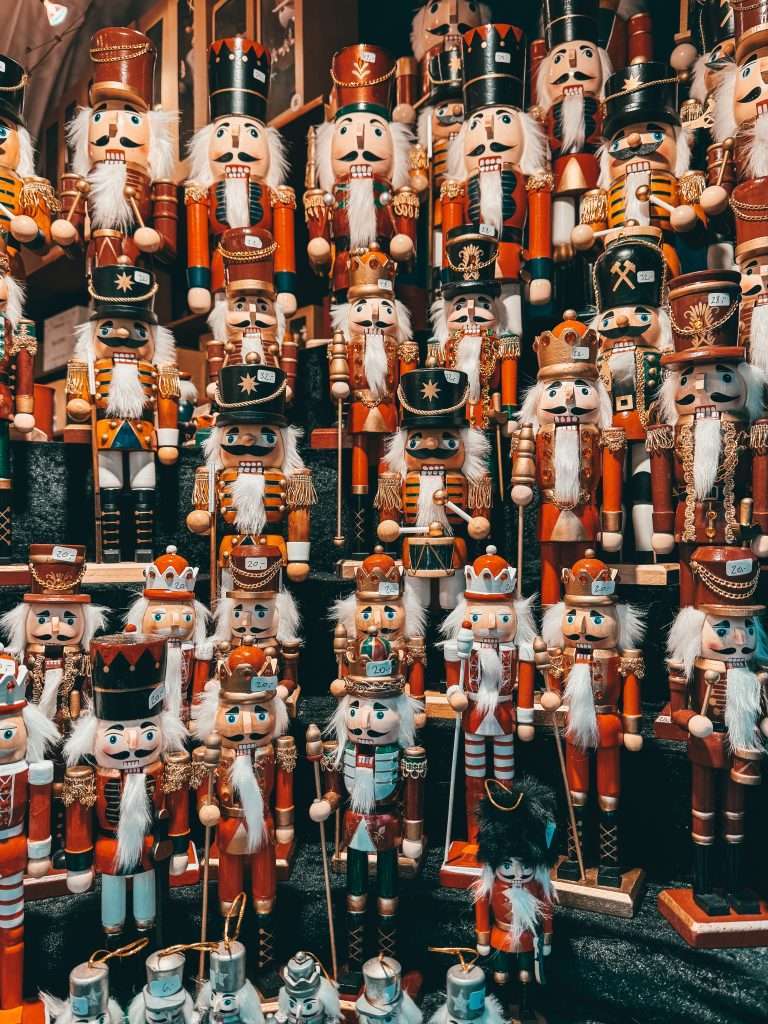 Frankfurt Christmas Markets bustling with holiday cheer, featuring traditional wooden stalls, festive lights, and seasonal decorations, with the historic architecture of the city in the background Seeds of Travel
