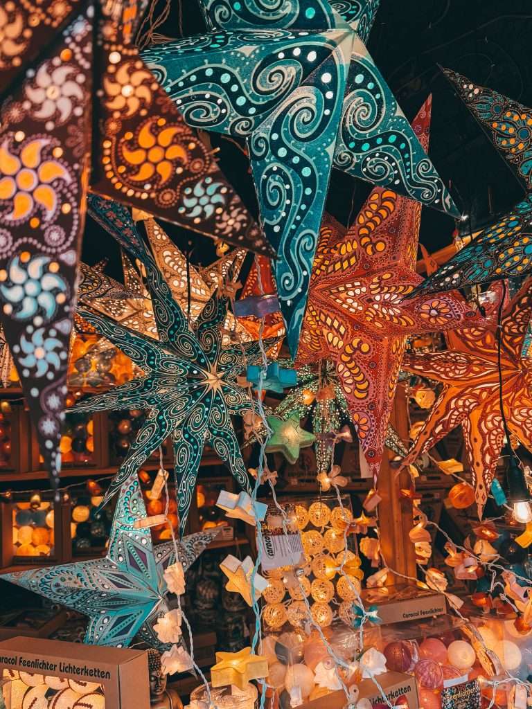 Frankfurt Christmas Markets bustling with holiday cheer, featuring traditional wooden stalls, festive lights, and seasonal decorations, with the historic architecture of the city in the background Seeds of Travel