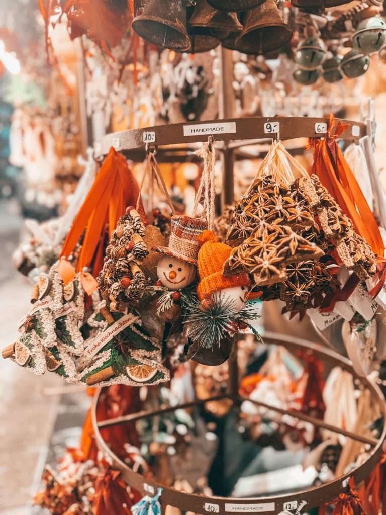 Festive Christmas decorations at the Munich Christmas Markets, featuring twinkling lights, colorful ornaments, and charming wooden stalls adorned with holiday garlands