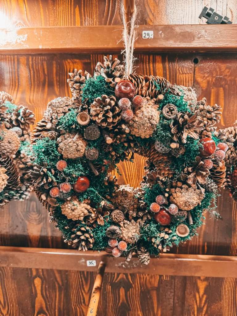 Festive Christmas decorations at the Munich Christmas Markets, featuring twinkling lights, colorful ornaments, and charming wooden stalls adorned with holiday garlands