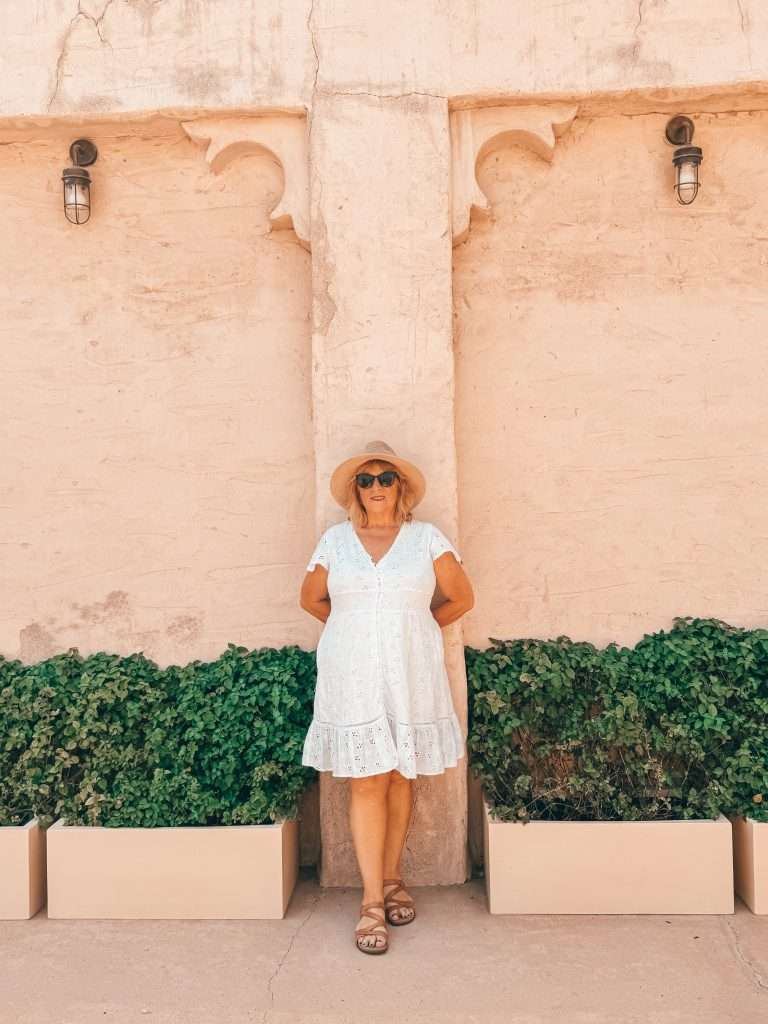 Lady relaxing against wall in Dubai Old Town