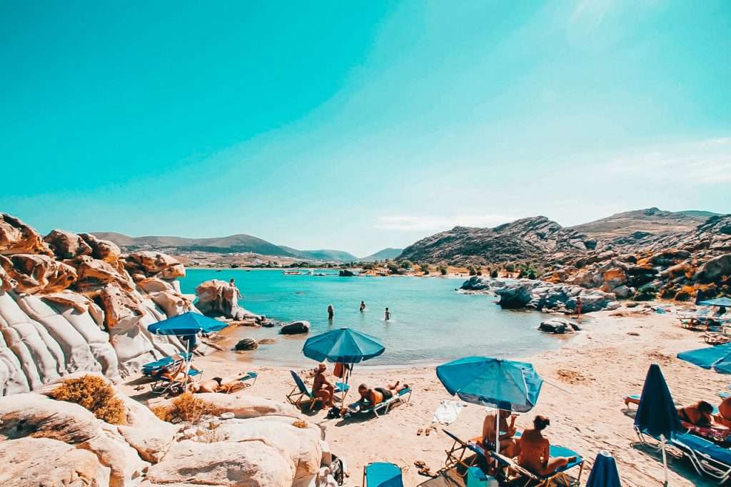 Paros Beaches People Sunbathing next to interesting rock formations