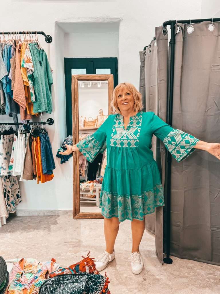 Lady trying on dress in shop Naoussa Greece